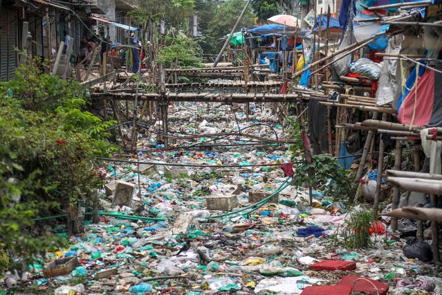 A view of Kajla canal filled with household garbage and plastic in Dhaka, Bangladesh, 08 July 2024. According to the Dhaka South City Corporation Waste Management official, several canals were cleaned at the end of July last year, however most of the canals of the city remain clogged with garbage and plastic thrown by local residents. (Photo by Monirul Alam/EPA/EFE)