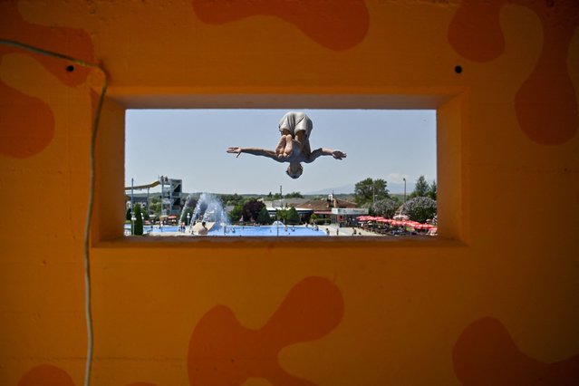 A man dives at a swimming pool in the village of Zllakuqan near the town of Klina, Kosovo on July 9, 2024. (Photo by Armend Nimani/AFP Photo)