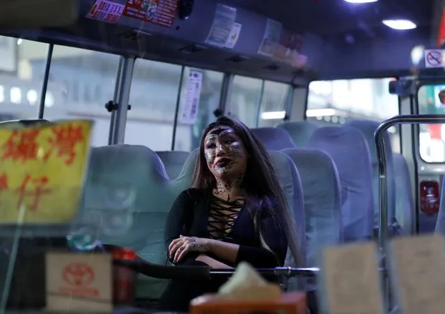 A passenger wearing Halloween make-up sits on a bus as the bus is stopped by anti-government protesters during a protest on Halloween day in Hong Kong, China on October 31, 2019. (Photo by Kim Kyung-Hoon/Reuters)