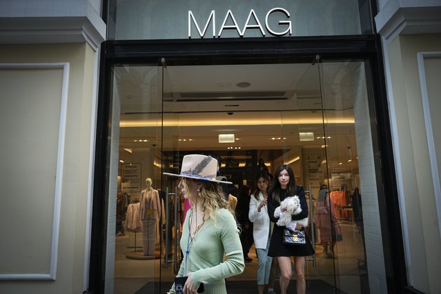 A woman exits a newly opened Maag store, a former Zara flagship store, in Moscow, Russia, Thursday, April 27, 2023. When Russia invaded Ukraine, companies were quick to respond, some announcing they would get out of Russia immediately, others vowed to curtail sales and new investment. More than a year later, it’s clear: Leaving Russia isn't as easy as the first announcements might have made it seem. (Photo by Alexander Zemlianichenko/AP Photo)