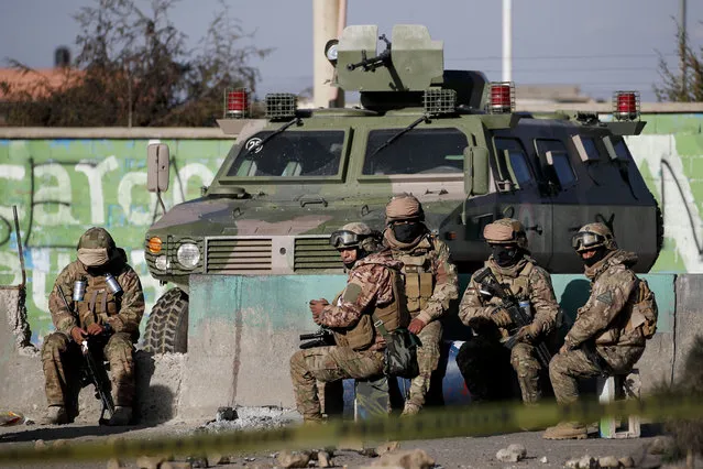 Soldiers guard the Senkata fuel plant in El Alto, on the outskirts of La Paz, Bolivia, Wednesday, November. 20, 2019. Police and soldiers on Tuesday escorted gasoline tankers from the plant, that had been blockaded for five days by supporters of former President Evo Morales, and at least three people were reported killed while the operation was underway. (Photo by Natacha Pisarenko/AP Photo)