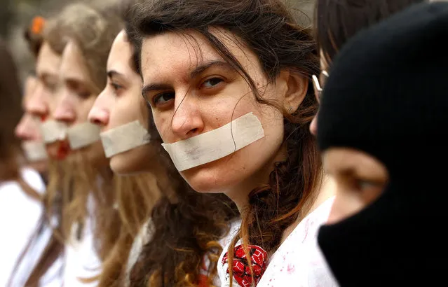 Women stage a protest during the women's demonstration “The real price of Russian gas and oil” to protest against Russia's invasion of Ukraine, in Berlin, Germany, April 21, 2022. (Photo by Lisi Niesner/Reuters)