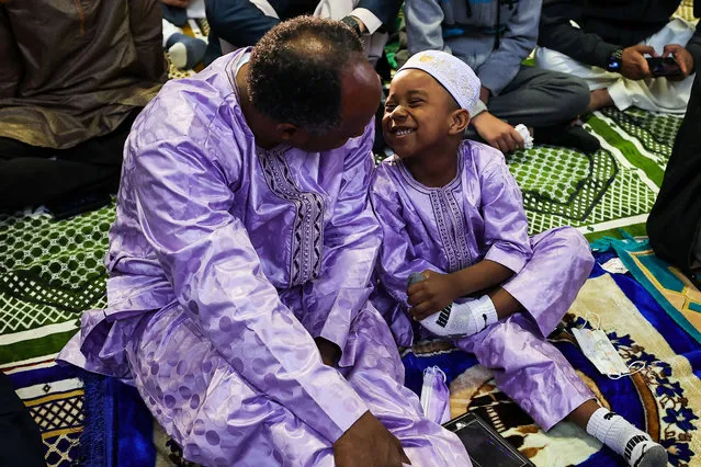 A Muslim man is seen with his son as Eid al-Fitr, the Muslim festival marking the end of the fast of Ramadan is celebrated at the Teaneck National Guard Armory in New Jersey, United States on May 2, 2022. (Photo by Tayfun Coskun/Anadolu Agency via Getty Images)