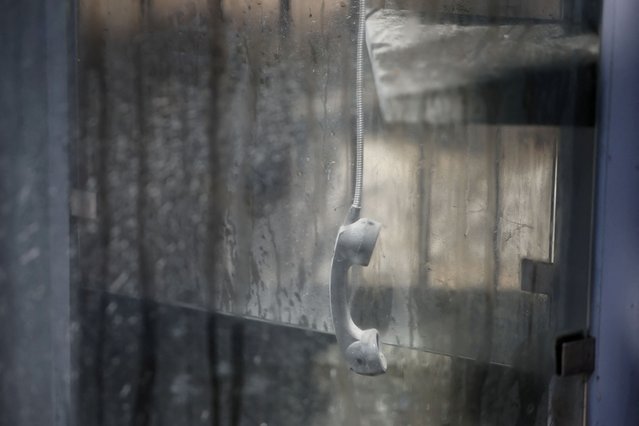 A handset is seen in a damaged phone booth, a day after an Israeli strike on residential buildings in Maaysrah, north of Beirut, Lebanon on September 26, 2024. (Photo by Louisa Gouliamaki/Reuters)