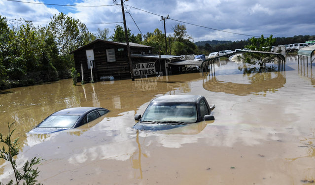 Cars sit submerged in a flooded area at a used tire dealership after Tropical Storm Helene in Hendersonville, North Carolina, September 27, 2024. (Photo by Ken Ruinard/USA TODAY Network)
