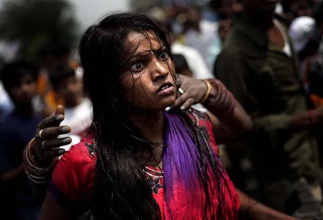 A devotee of Hindu goddess Maha Mariamman dances in trance during a religious procession in Amritsar, India on May 13, 2012