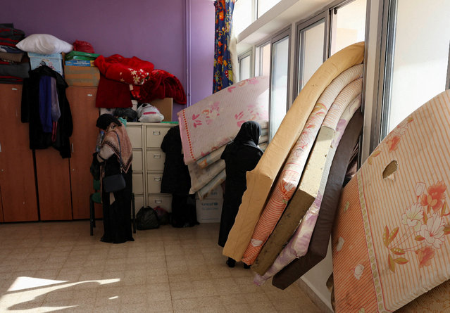 Women stand near mattresses placed on the windows of a school turned into a shelter housing displaced people who fled from Baalbek and surrounding areas, in Deir Al-Ahmar, amid ongoing hostilities between Hezbollah and Israeli forces, Lebanon on October 31, 2024. (Photo by Mohamed Azakir/Reuters)