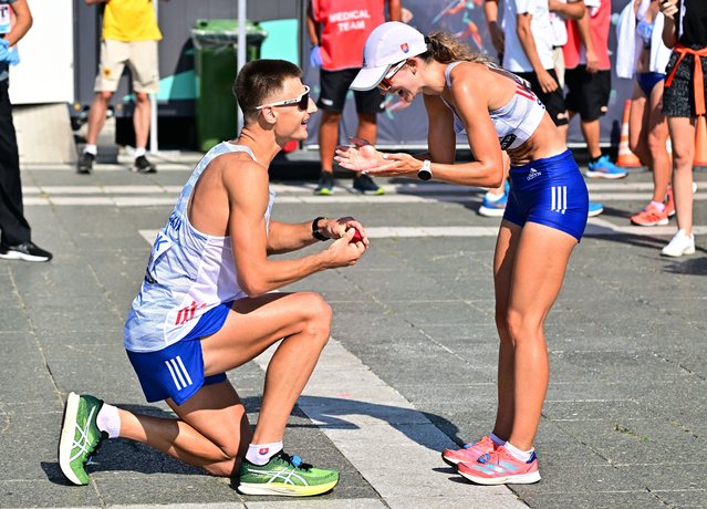 Slovakia's Dominik Cerny proposes to Slovakia's Hana Burzalova after the women's 35km race walk final during the World Athletics Championships in Budapest on August 24, 2023. (Photo by Marton Monus/Reuters)