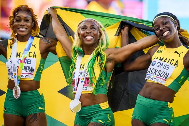 Gold medalist Shelly-Ann Fraser-Pryce of Jamaica (C), reacts after the women's 100 meter final next to Elaine Thompson-Herah of Jamaica (L), and Shericka Jackson of Jamaica (R), during the IAAF World Athletics Championships, at  Hayward Field stadium, in Eugene, Oregon, USA, 17 July 2022. (Photo by Jean-Christophe Bott/EPA/EFE)