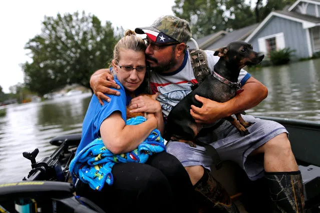 David Gonzalez comforts his wife Kathy after being rescued from their home flooded by Tropical Storm Harvey in Orange, Texas, U.S., August 30, 2017. (Photo by Jonathan Bachman/Reuters)