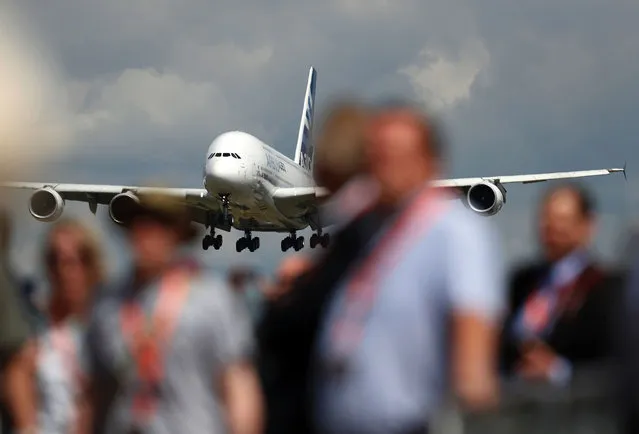 An Airbus A380 aircraft prepares to land after performing in a flying display at the Farnborough Airshow, south west of London, on July 14, 2016. The event, held every two years southwest of London, traditionally sees US titan Boeing and Europe's Airbus compete as they unveil their latest multi-billion-dollar orders. (Photo by Adrian Dennis/AFP Photo)