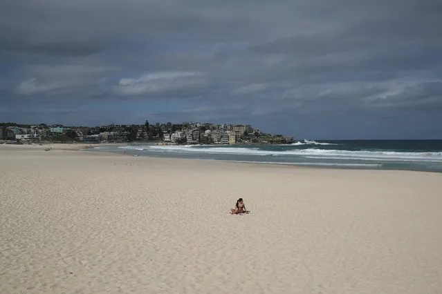 A single sunbather remains following the closure of Bondi Beach after thousands of peopled flocked there in recent days, defying social distancing orders to prevent the spread of the coronavirus disease (COVID-19), in Sydney, Australia, March 21, 2020. (Photo by Loren Elliott/Reuters)