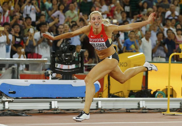 Second placed Cindy Roleder of Germany crosses the finish line to win silver at the women's 100 metres hurdles final during the 15th IAAF World Championships at the National Stadium in Beijing, China, August 28, 2015. (Photo by Kai Pfaffenbach/Reuters)