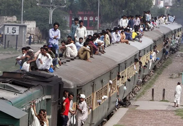 Pakistani passengers ride on crowded train returning from their hometown and villages after celebrating the Eid al-Fitr holiday to mark the end of the Muslim holy fasting month of Ramadan, to Lahore, Pakistan, Monday, July 11, 2016. (Photo by K.M.Chaudary/AP Photo)