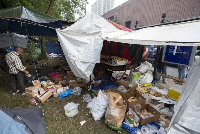 An asylum seeker collects some food in a makeshift camp outside the foreign office in Brussels, Belgium September 3, 2015. (Photo by Yves Herman/Reuters)