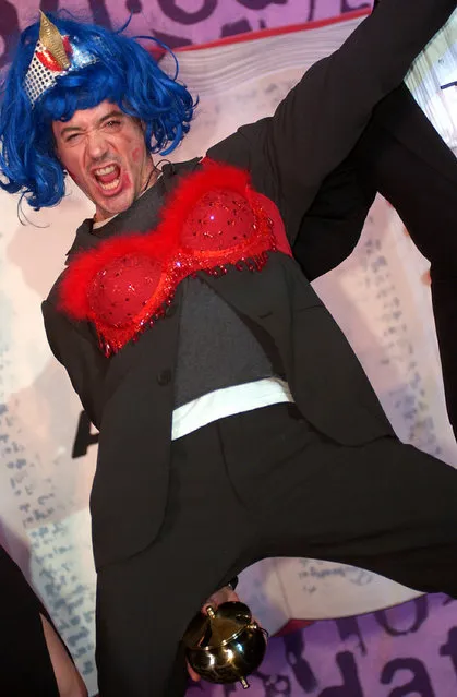 Hasty Pudding Theatricals Man of the Year, Robert Downey Jr., gestures while in drag after his roast at the Hasty Pudding Theater February 19, 2004 in Cambridge, Massachusetts. Downey, the 38th recipient of the annual award, joked about being the only convicted felon to have ever won the prestigious award which was also presented to Film Director Martin Scorsese in 2003.  (Photo By Douglas McFadd/Getty Images)
