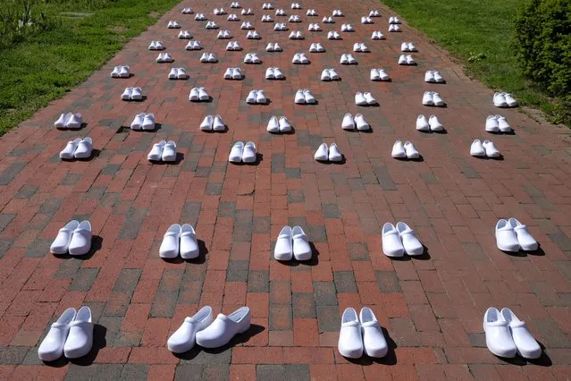 White shoes are displayed during a demonstration by Registered Nurses and the National Nurses United (NNU) members, on behalf of healthcare workers nationwide who have passed away due to the coronavirus, during a protest outside the White House in Washington, May 7, 2020. At least 90,000 health-care workers worldwide are believed to have been infected with COVID-19, and possibly twice that, amid reports of continuing shortages of protective equipment, the International Council of Nurses said on May 6. The disease has killed more than 260 nurses, it said in a statement, urging authorities to keep more accurate records to help prevent the virus from spreading among staff and patients. (Photo by Tom Brenner/Reuters)