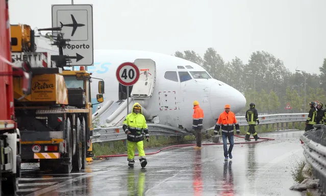 The DHL courier company's Boeing 737-400 cargo aircraft rests on a road after it came off the runway after landing at the airport of Bergamo Orio al Serio, Italy, 05 August 2016. (Photo by Matteo Bazzi/EPA)