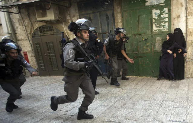 Israeli border police scuffle with Palestinians prevented from entering to Al-Aqsa mosque compound in the Old City of Jerusalem, during the Jewish New Year holiday, 14 September 2015. For the second day, Israeli police enter to the Al-Aqsa mosque compound, to prevent riots during the visit of Jews tourism to Al-Aqsa mosque compound, also called the Temple Mount. (Photo by Atef Safadi/EPA)