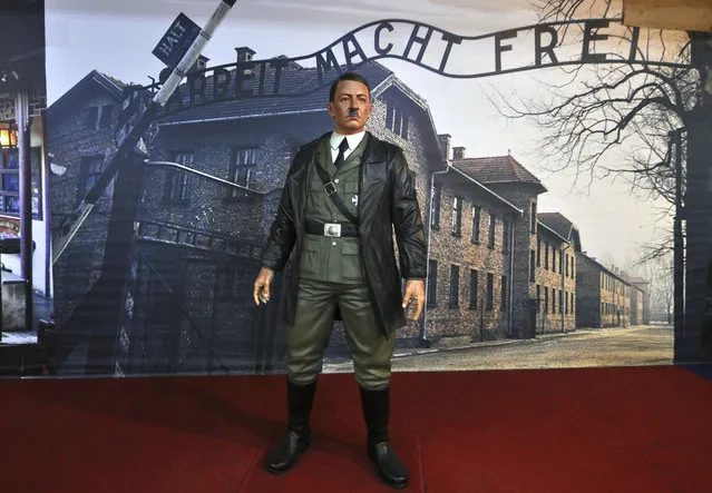 In this Wednesday, November 8, 2017, photo, a wax figure of Adolf Hitler is displayed against the backdrop of an image of Auschwitz-Birkenau complex of concentration camps, at De Mata Museum in Yogyakarta, Indonesia. Rights groups have expressed outrage over the display calling it “sickening” and that “It mocks the victims who went in and never came out”. (Photo by Slamet Riyadi/AP Photo)
