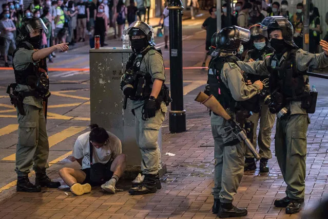 Riot police detain a man after they cleared protesters taking part in a rally against a new national security law in Hong Kong on July 1, 2020, on the 23rd anniversary of the city's handover from Britain to China. Hong Kong police made the first arrests under Beijing's new national security law on July 1 as the anniversary of the city's handover to China was met by thousands defying a ban on protests. (Photo by Dale de la Rey/AFP Photo)