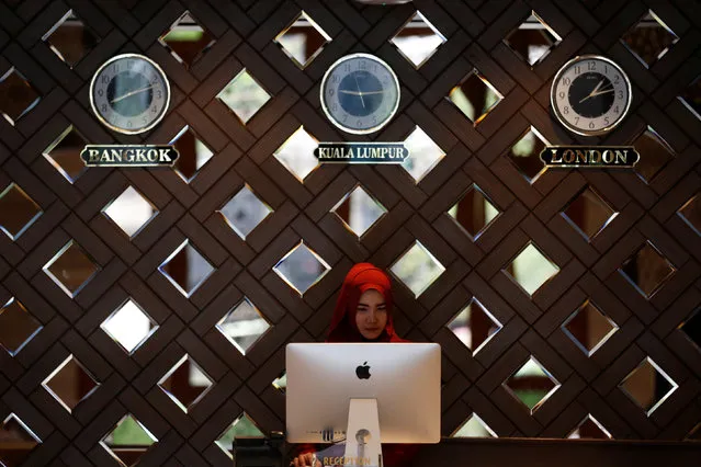A receptionist works at the Al Meroz hotel in Bangkok, Thailand, August 29, 2016. Predominately Buddhist Thailand has opened its first halal hotel as hopes to attract more Muslim visitors and boost one of the few bright spots in its economy. Nearly 30 million foreign tourists came to Thailand last year but only about 658,000 were from the Middle East, according to industry data. The four-star Al Meroz hotel in Bangkok, which opened in November, hopes to play its part in changing that, and to cash in. The Al Meroz, which boasts mosque-like architecture, has two prayer rooms and three halal dining halls. (Photo by Chaiwat Subprasom/Reuters)