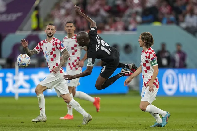 Canada's Atiba Hutchinson, center, vies for the ball with Croatia's Marcelo Brozovic, left, and Luka Modric during the World Cup group F soccer match between Croatia and Canada, at the Khalifa International Stadium in Doha, Qatar, Sunday, November 27, 2022. (Photo by Martin Meissner/AP Photo)