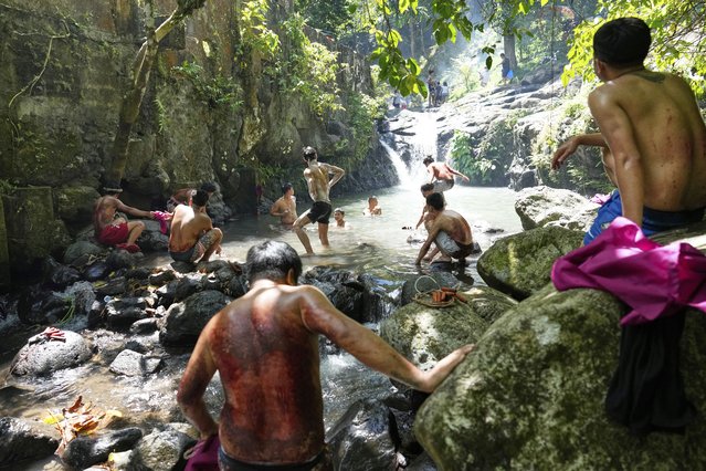 Penitents wash their bloodied backs after flagellating themselves on Good Friday in Kalayaan town, Laguna province, Philippines, April 18, 2025. (Photo by Aaron Favila/AP Photo)