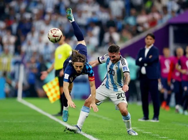 Alexis Mac Allister of Argentina in action with Luka Modric of Croatia during the FIFA World Cup Qatar 2022 semi final match between Argentina and Croatia at Lusail Stadium on December 13, 2022 in Lusail City, Qatar. (Photo by Kai Pfaffenbach/Reuters)
