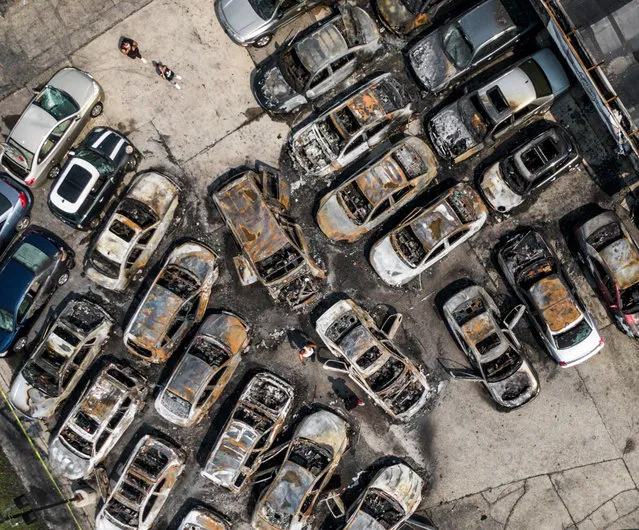 An aerial photo made with a drone shows burned out automobiles after a night of unrest in Kenosha, Wisconsin, USA, 24 August 2020. According to reports a black man, Jacob Blake, was shot by a Kenosha police officer or officers on 23 August setting off protests and unrest. Blake was taken by air ambulance to a Milwaukee, Wisconsin hospital and protests started after a video of the incident was posted on social media. (Photo by Tannen Maury/EPA/EFE)