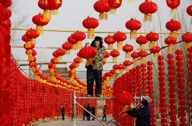 Workers install red lanterns ahead of the Chinese Lunar New Year, or Spring festival, at a tourist attraction in Linyi, Shandong province, China January 31, 2018. (Photo by Reuters/China Stringer Network)