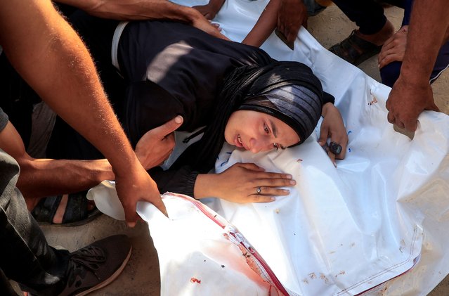 A mourner reacts during the funeral of Palestinians killed in what the Gaza health ministry says was Israeli fire near a distribution center in Rafah, at Nasser Hospital in Khan Younis, in the southern Gaza Strip, on June 16, 2025. (Photo by Hatem Khaled/Reuters)