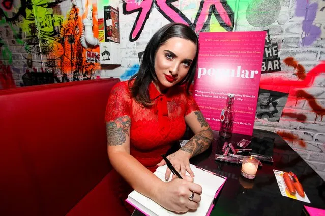 Lauren Urasek signs a copy of her book during the book release party of "Popular" on October 15, 2015 in New York City. (Photo by Donald Bowers/Getty Images for Lauren Urasek)
