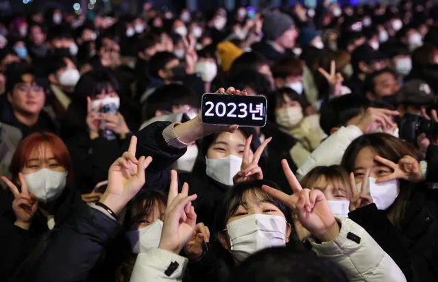 People celebrate New Year's eve in Seoul, South Korea on December 31, 2022. (Photo by Kim Hong-Ji/Reuters)