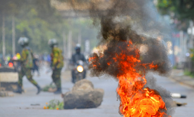 Smoke and fire rise at the site after riot police officers dispersed protesters during demonstrations to mark the first anniversary of the deadly 2024 anti-government protests that drew widespread condemnation over the use of force by security agencies, in Nairobi, Kenya on June 25, 2025. (Photo by John Muchucha/Reuters)