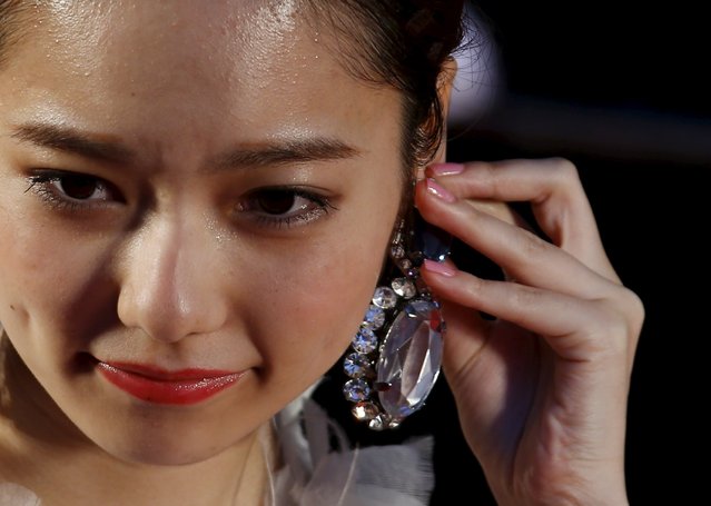 Japanese singer Haruka Shimazaki adjusts her ear rings as she arrives at the red carpet at the Tokyo International Film Festival in Tokyo October 22, 2015. (Photo by Thomas Peter/Reuters)