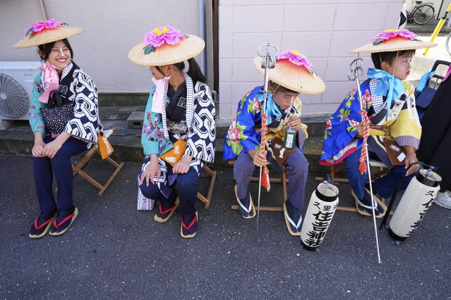 “Kanabo‑san”, costumed children who lead the procession, rest during a procession at the annual Kurihama Sumiyoshi Shrine Festival at Kurihama, Yokosuka city, south of Tokyo Sunday, July 27, 2025. (Photo by Eugene Hoshiko/AP Photo)