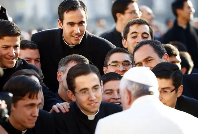 Pope Francis, who's 78th birthday is today, greets priests as he arrives to lead his general audience at the Vatican, December 17, 2014. (Photo by Tony Gentile/Reuters)
