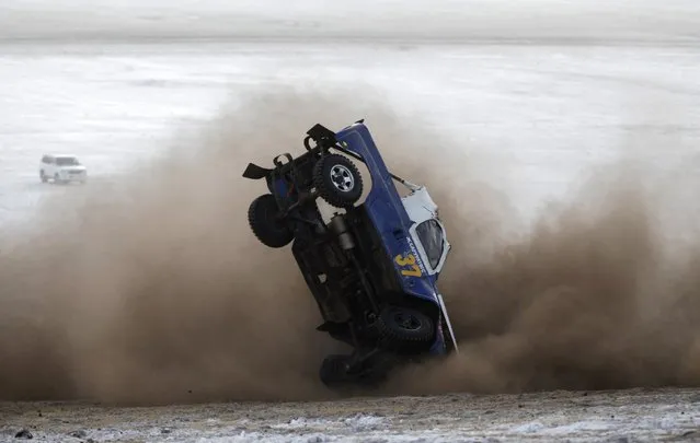 A car overturns during the Master Cross Race 2014 at Suuj Uul, outside Ulan Bator, December 14, 2014. (Photo by B. Rentsendorj/Reuters)