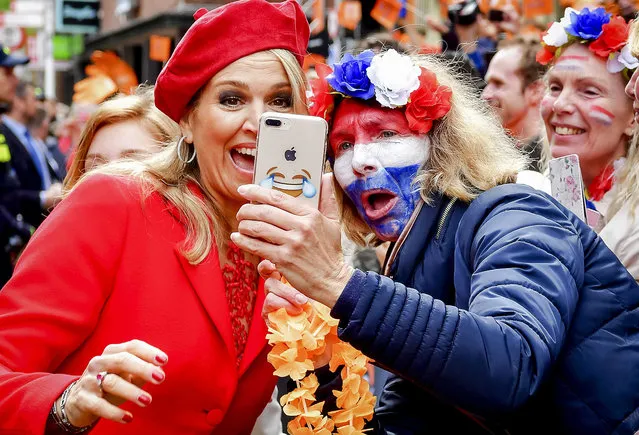 Dutch Queen Maxima (L) poses for a picture with fan as she attends the traditional King's Day celebrations in Groningen, the Netherlands, 27 April 2018. King's Day is the celebration of the birthday of the Dutch King Willem-Alexander, who celebrates 51th birthday today. (Photo by Robin Utrecht/EPA/EFE)