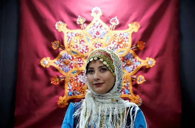 An Iranian woman wearing Gilaki traditional outfit attends the 16th International Exhibition of Tourism and Related Industries at the Tehran's international exhibition complex in Tehran, Iran, 08 February 2023. The exhibition runs until 10 February 2023. (Photo by Abedin Taherkenareh/EPA/EFE)