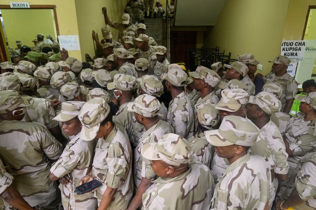 Soldiers wait to cast their votes during early voting in the general elections at the Tumekuja Secondary School polling station in Zanzibar, Tanzania, Tuesday, October 28, 2025. (Photo by Brian Inganga/AP Photo)