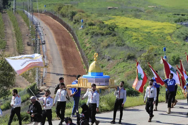 Hezbollah al-Mahdi scouts, carry a replica of the Dome of the Rock Mosque, as they march during a rally to mark Jerusalem day, at the Lebanese-Israeli border village of Kfar Kila, south Lebanon, Friday, April 14, 2023. Since Iran's Islamic Revolution in 1979, the rallies marking what is also known as al-Quds Day have typically been held on the last Friday of the Muslim holy month of Ramadan. (Photo by Mohammed Zaatari/AP Photo)