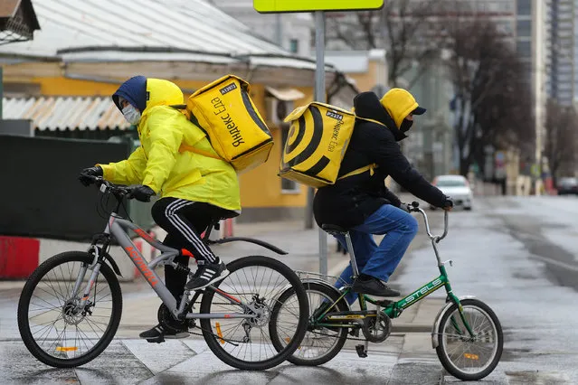 Yandex.Eda food delivery service employees by Barrikadnaya Station of the Moscow Metro in Moscow, Russia on April 12, 2020. Russian President Vladimir Putin has expanded non-working period till April 30, 2020 to prevent the spread of the novel coronavirus. (Photo by Sergei Savostyanov/TASS via Getty Images)