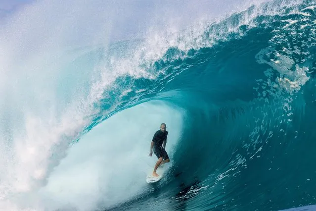 USA's surfer Ivan Florence rides a wave as a big swell hits Teahupoo, Tahiti on April 30, 2023. (Photo by Brian Bielmann/AFP Photo)