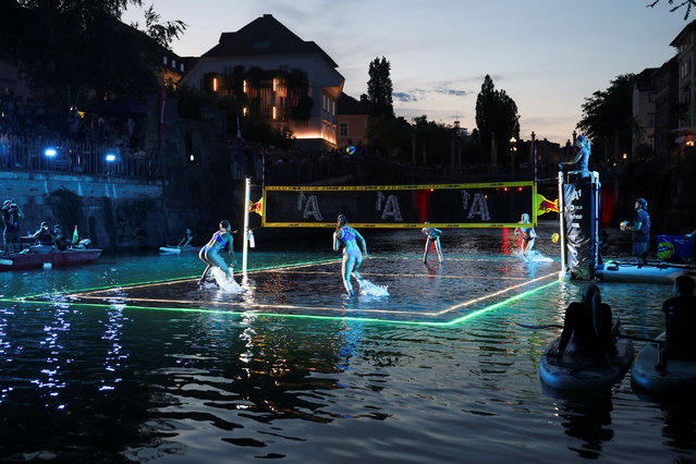 People play volleyball as Slovenia's capital Ljubljana hosts an international “Volleyball on Water” tournament where teams compete on a floating and partially submerged court in the city's Ljubljanica river, in Ljubljana, Slovenia on July 6, 2024. (Photo by Borut Zivulovic/Reuters)