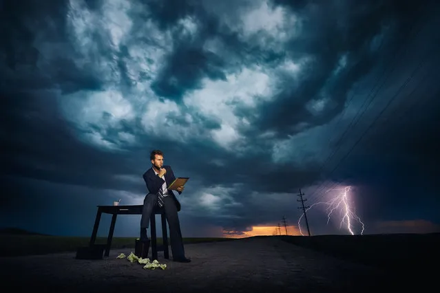 A thrill-seeking snapper has shot a powerful series of images featuring people carrying out everyday chores in front of giant storms. Benjamin Von Wong's surreal scenes include individuals ironing, barbecuing, playing video games and even sitting on the toilet – seemingly unaware of the threatening situations approaching. Here: Models pose in front of a storm in Cheyenne Wyoming. (Photo by Benjamin Von Wongs/Caters News)