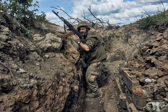 A Ukrainian soldier is seen in a trench at the frontline near Bakhmut in the Donetsk region, Ukraine, Monday, May 22, 2023. (Photo by Libkos/AP Photo)
