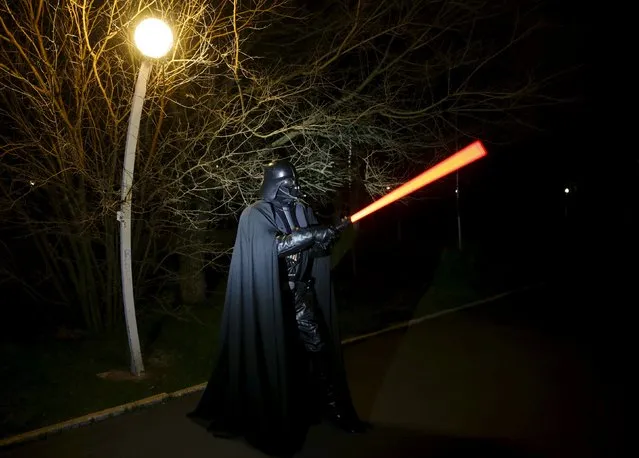 Darth Mykolaiovych Vader, who is dressed as the Star Wars character Darth Vader, poses for a picture as he demonstrates exercises with a lightsaber in a park in Odessa, Ukraine, December 3, 2015. (Photo by Valentyn Ogirenko/Reuters)