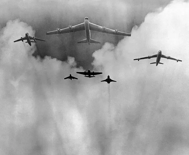 When the H bomb is dropped on Namu, tiny atoll near Kwajalein in the Marshall Islands, these planes, shown on May 16, 1956, will play supporting roles. Led by the huge B52 Stratofortress, which will drop the bomb, the other planes top row, left to right: B66, B52, and B47. Rear row, left to right: F84, B57 and RF101. The bomb was scheduled to be dropped, but a short time before drop time was postponed for the eighth time. It was rescheduled for the next day. (Photo by AP Photo)